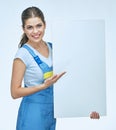 Woman builder holding white blank advertising banner point finger on copy space.