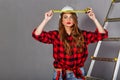 Woman builder holds tape measure Royalty Free Stock Photo