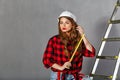 Woman builder holds tape measure Royalty Free Stock Photo