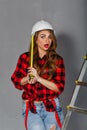 Woman builder holds tape measure Royalty Free Stock Photo