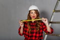 Woman builder holds tape measure Royalty Free Stock Photo