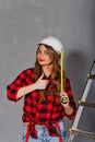 Woman builder holds tape measure Royalty Free Stock Photo