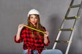 Woman builder holds tape measure Royalty Free Stock Photo