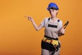 Woman builder indicating direction on left side Royalty Free Stock Photo