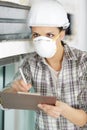 woman in builder respirator indoor Royalty Free Stock Photo