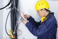 woman builder worker in uniform testing wire tension Royalty Free Stock Photo