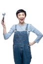 Woman builder worker with wrench standing against white background Royalty Free Stock Photo