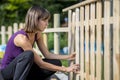 Woman building a garden fence