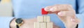 Woman building pyramid from wooden cubes closeup Royalty Free Stock Photo