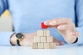 Woman building pyramid from wooden cubes closeup Royalty Free Stock Photo