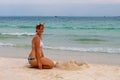 Woman building sand castle on beach. Relaxed smiling woman in bikini. Beach day activity. Royalty Free Stock Photo