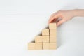 Woman building stairs with cubes on white background, top view. Career promotion concept