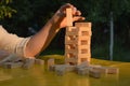 Woman builds a tower with wooden blocks as an analogy of balance life