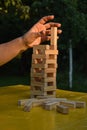 Woman builds a tower with wooden blocks as an analogy of balance life