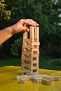 Woman builds a tower with wooden blocks as an analogy of balance life