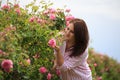 Woman in a Bulgarian pink rose garden