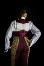 Woman bullfighter by dressing with vest on your back