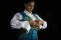 Woman bullfighter by dressing with vest on your back