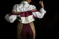 Woman bullfighter by dressing with vest on your back