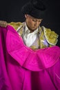 Woman bullfighter holding capote pink Royalty Free Stock Photo