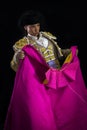 Woman bullfighter holding capote pink Royalty Free Stock Photo