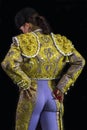 Woman bullfighter posing suit on his back