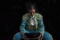 Woman bullfighter sitting on a chair looking at his montera