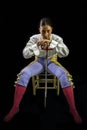 Woman bullfighter sitting on a wooden chair