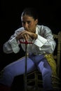 Woman bullfighter sitting on a wooden chair