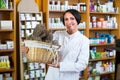 Woman with bunch of dried herbs in drugstore Royalty Free Stock Photo