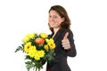 Woman with bunch of flowers posing with thumbs up