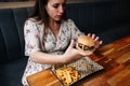 Woman burger eating. Hungry Girl Biting Hamburger. Fast food, people and unhealthy eating concept.