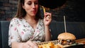 Woman burger eating. Hungry Girl Biting Hamburger. Fast food, people and unhealthy eating concept.