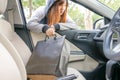 Woman burglar steal a shopping bag through the window of car - t Royalty Free Stock Photo