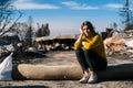 Woman at burned ruined house and yard, after fire disaster Royalty Free Stock Photo