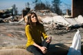 Woman at burned ruined house and yard, after fire disaster Royalty Free Stock Photo