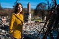 Woman at burned ruined house and yard, after fire disaster Royalty Free Stock Photo