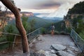 Woman at a bushwalking lookout with a view over a remote bushfire and smoke in the Blue Mountains, New South Wales, Australia. Royalty Free Stock Photo