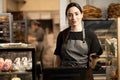 woman business owner with bakery shop background near showcases with pastries Royalty Free Stock Photo