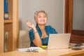 Lifestyle portrait of Happy and attractive elegant middle aged Asian business woman working smiling at office computer desk Royalty Free Stock Photo