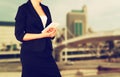Woman in business suit on a city building background. filtered image Royalty Free Stock Photo