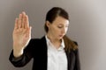 Woman in business suit showing her palm, body language, say NO a Royalty Free Stock Photo
