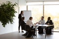 Woman business trainer and workers gathered together in conference room Royalty Free Stock Photo