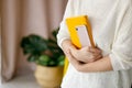 Woman businessman holding yellow notepad and smartphone Royalty Free Stock Photo