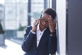 Woman businessman sad complains on the phone, reports bad news, African American woman in despair near the office, holding hands Royalty Free Stock Photo