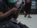 a woman busy with her phone while sitting in the town square