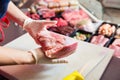 Woman in butcher shop selling meat fillet