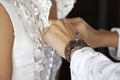 Woman buttoning a wedding dress