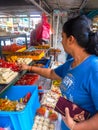 Woman buying assorted Indian sweets in Little India Town