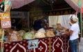 A woman is buying an assortment of tea and typical Arabian sweet pastries.